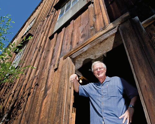 Bob Russell standing in the window of the Butte Creek Mill. Photo by Jamie Lusch, courtesy of Oregon Business Magazine.
