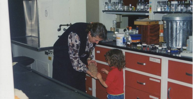 Evolutionary biologist Lynn Margulis, Ph.D., showing a fossil to her granddaughter at her laboratory at University of Massachusetts, Amherst. Photo credit: Jennifer Margulis