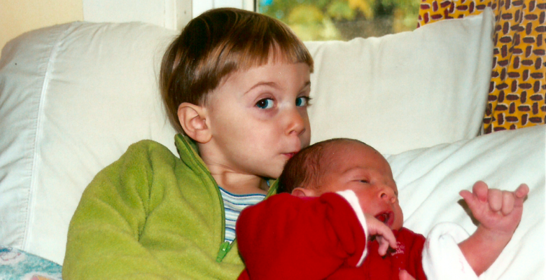 Big sister kisses her newborn baby brother on the head. He was born perfect. No need to cut off part of his penis. Via JenniferMargulis.net
