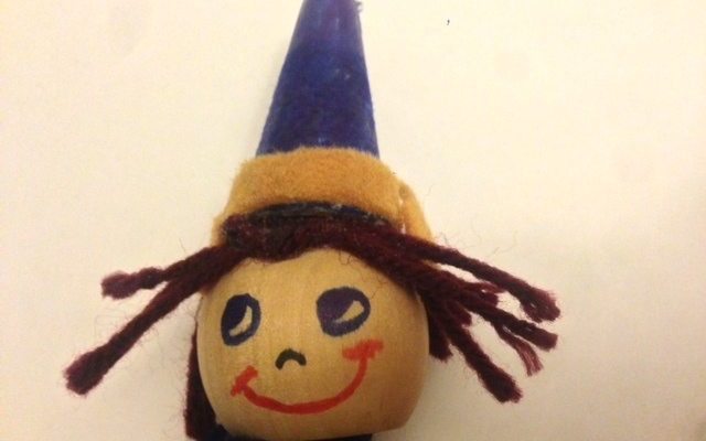 An elf pop-up puppet wearing a blue hat with a khaki rim and brown yarn for hair | Photo credit Jennifer Margulis, Ph.D.
