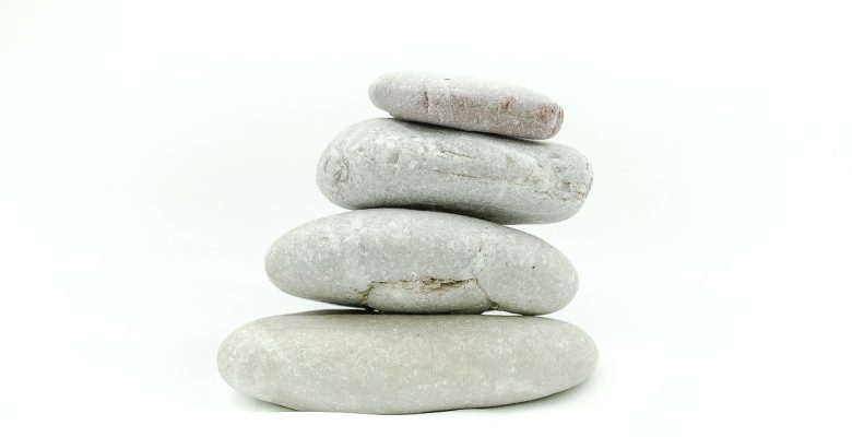 Excellent advice on how to meditate. Photo of four rocks piled up on a white background via Pixabay. | Jennifer Margulis