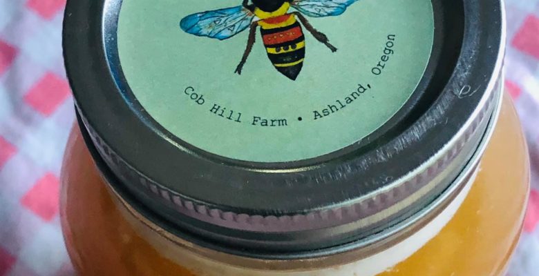 Glyphosate in honey, even organic honey, is a growing problem, according to several scientific studies. Photo of a jar of Working Girls Raw Honey with original art by Jennifer Margulis