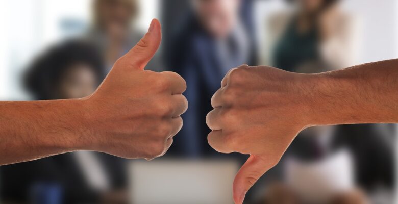 healthcare workers refusing covid vaccines, a medical doctor explains why. Photo of one hand with a thumbs up, one with a thumbs down. Courtesy of Pixabay. | Jennifer Margulis, Ph.D.