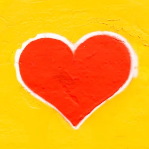 Red heart on a yellow background by Nicola Fioravanti, courtesy of Unsplash. Can you test for vaccine-induced myocarditis? Can you treat it? | Jennifer Margulis, Ph.D.